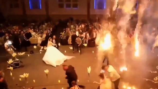 During the bride and groom’s first dance, the event turned into chaos as flaming debris fell on attendees and staff. Picture: X