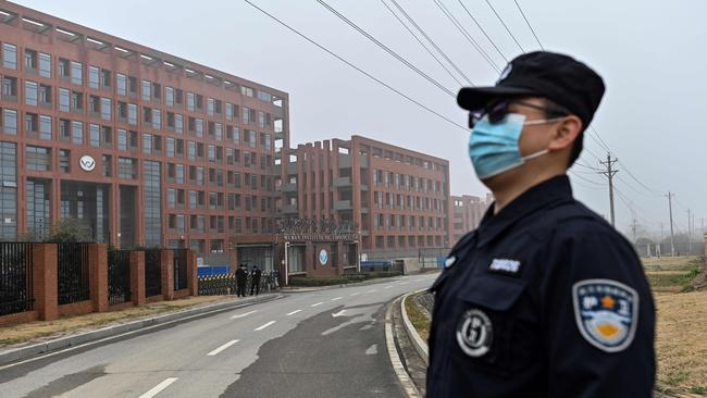 A security staffer stands guard as members of the World Health Organisation (WHO) team investigating the origins of the COVID-19 coronavirus, make a visit to the Wuhan Institute of Virology in Wuhan. Picture: Hector Retmal/AFP