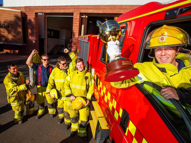 Firefighter Shane Rodwell holds the Cup as it visits the Alice Springs fire brigade. Picture: Mark Stewart