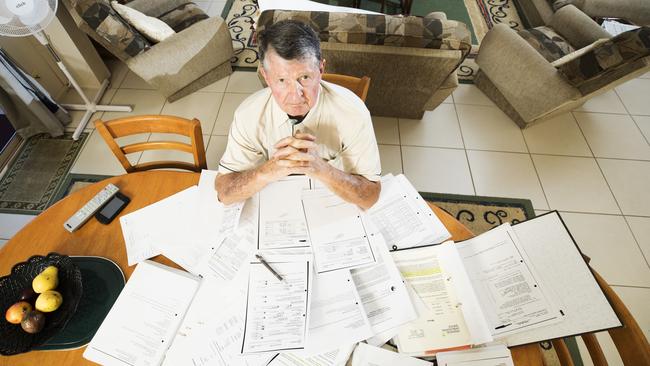 Palmwoods man Mark Weir, who has led a nine year fight against Storm Financial Founders and Westpac surrounded by paperwork from his battle. Photo Lachie Millard