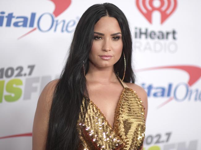 FILE - In this Dec. 1, 2017 file photo, Demi Lovato arrives at Jingle Ball at The Forum in Inglewood, Calif. Emergency officials confirm Tuesday, July 24, 2018, they transported a 25-year-old woman who lives on Demi Lovatoâ€™s block to the hospital amid reports that the pop star suffered a drug overdose. (Photo by Richard Shotwell/Invision/AP, File)