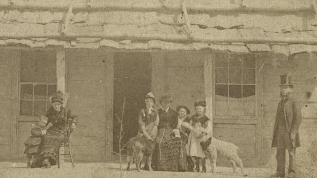 After her release from jail, Ellen Kelly (feeding a pet lamb) posed with what was left of her family outside the house that Ned built.