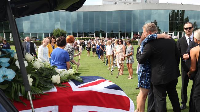 Hockey players form a Guard of Honour as the coffin leaves the service. Picture Glenn Hampson