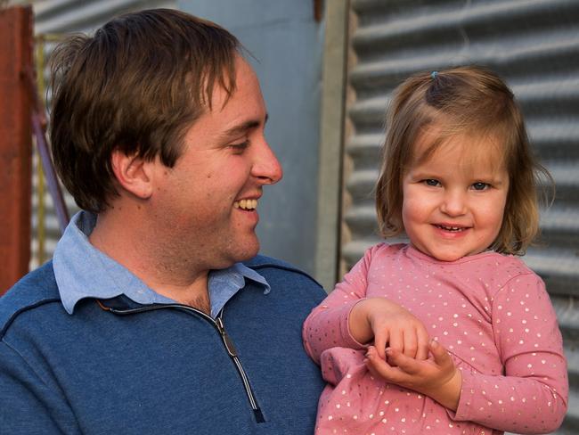 Jonathan Dyer with 2-year-old daughter Mabel. The Dyer family have a farm in Kaniva, western Victoria.  2 year old Mabel has a bone condition and needs to make frequent trips to Adelaide to see her specialist. Since the South Australian border closure the family is no longer allowed to enter SA to see the doctor and will instead have to go to Melbourne to find a new doctor for her. Jonathan's wife Tiarnee has written to the Prime Minister pleading for help.Photograph by Paul JeffersThe Australian14 Aug 2020