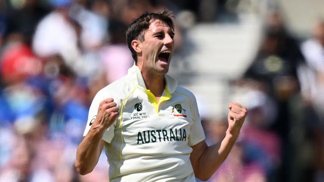 Pat Cummins celebrates dismissing India's captain Rohit Sharma for 15 runs.