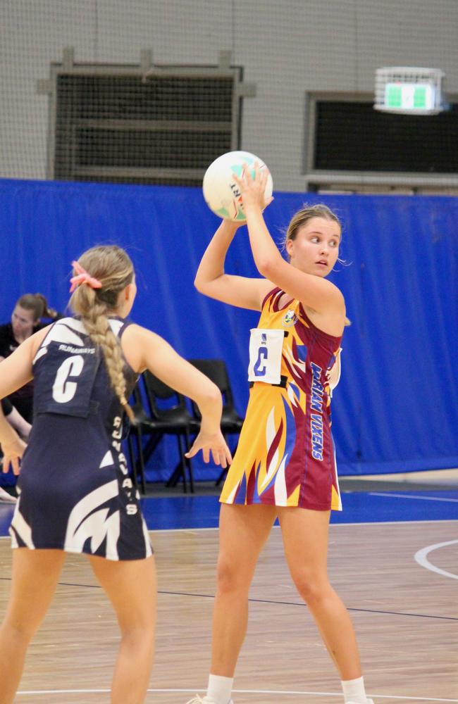 Marian Vixens player Shannon Perry is defended by Runaways centre Jess Freeman during Premier League netball in Townsville. Picture: Shaantel Hampson / TCNAI