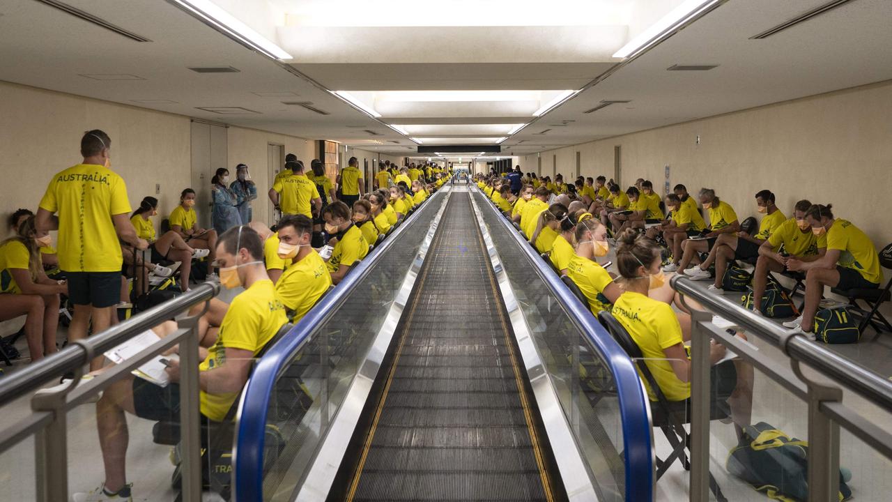 Members of the Australian delegation wait before being tested upon arrival at Narita International Airport. Picture: Charly Triballeau/AFP