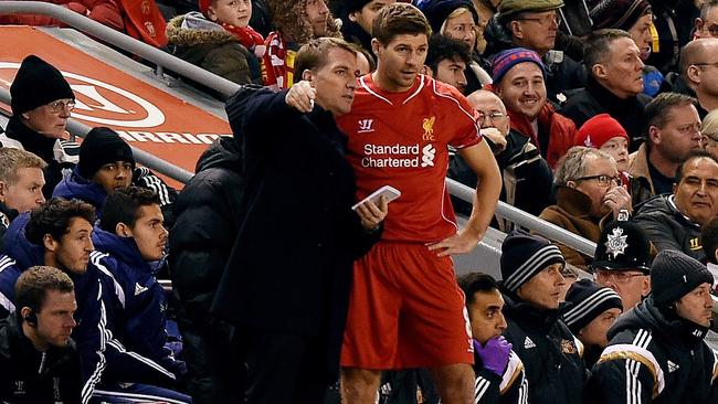 Liverpool manager Brendan Rodgers (L) gives instructions to Liverpool's English midfielder Steven Gerrard (R) on the touchline during the English Premier League football match between Liverpool and Sunderland at Anfield in Liverpool, north west England, on December 6, 2014. AFP PHOTO / PAUL ELLIS RESTRICTED TO EDITORIAL USE. No use with unauthorized audio, video, data, fixture lists, club/league logos or “live” services. Online in-match use limited to 45 images, no video emulation. No use in betting, games or single club/league/player publications.