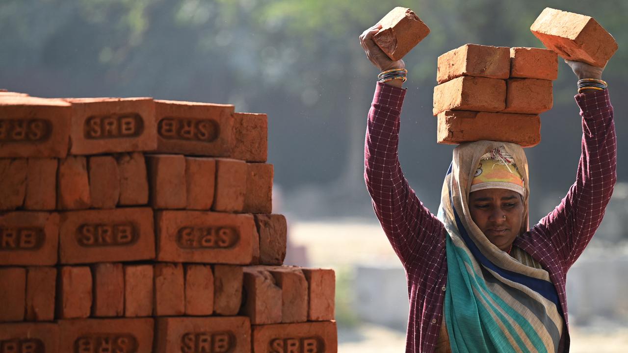 A labourer loads clay bricks on her head at a construction site in New Delhi. Picture: Sajjad Hussain/AFP