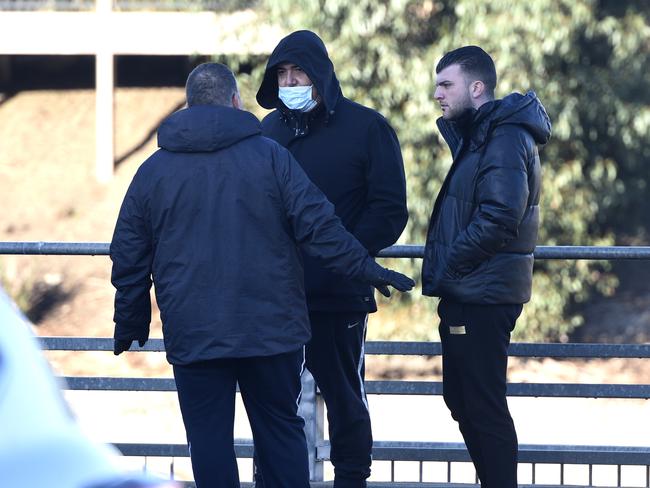 A group of men gather outside the La Porchetta restaurant on Wednesday. Picture: Andrew Henshaw