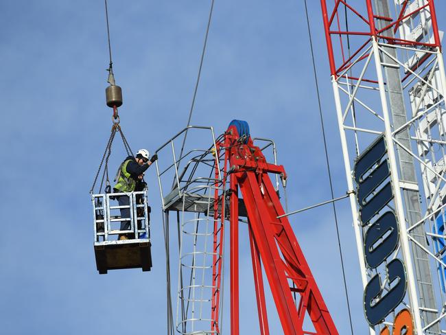 Workers begin dismantling the damaged crane. AAP Image/James Ross