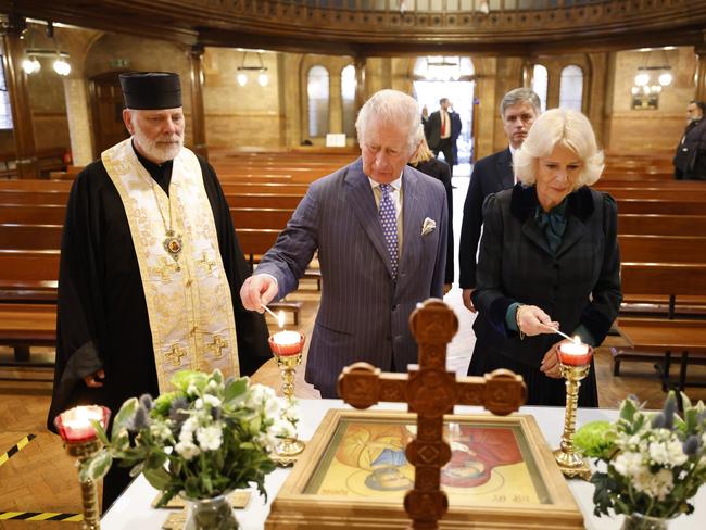 Prince Charles and Camilla light candles at the Ukrainian Catholic Cathedral, next to bishop Kenneth Nowakowski, in London. Picture: Getty Images