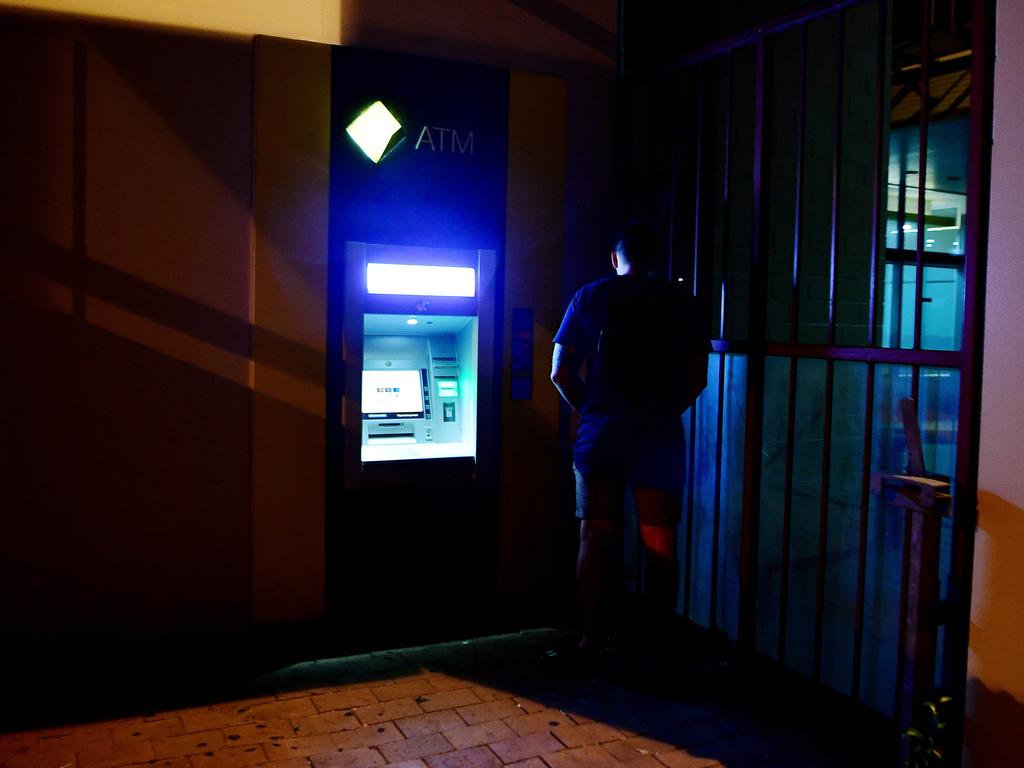 A young man finds a makeshift urinal on Mitchell Street in the early hours of New Year's day