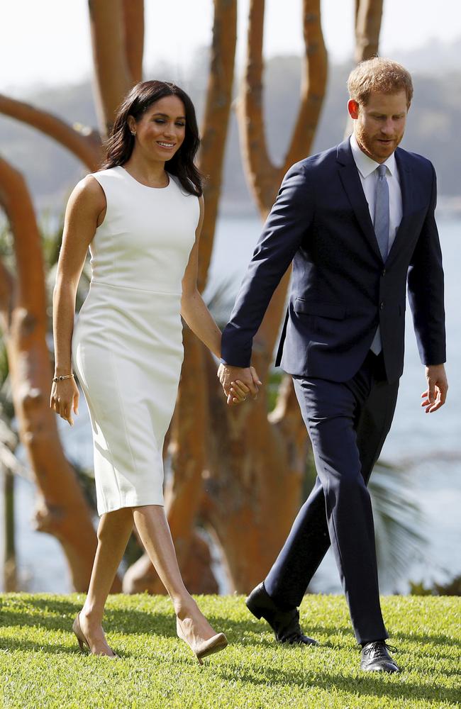 Britain's Prince Harry and Meghan, Duchess of Sussex walk hand-in-hand at Admiralty House.