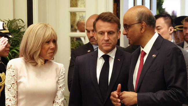 France's President Emmanuel Macron and his wife Brigitte Macron talk to Singapore's President Tharman Shanmugaratnam (R) as they arrive for a state lunch in Singapore on May 30, 2025. (Photo by Ludovic MARIN / AFP)