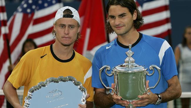 Lleyton Hewitt and Roger Federer after Federer won the men's final of the US Open in 2004. Photo by Clive Brunskill/Getty Images)