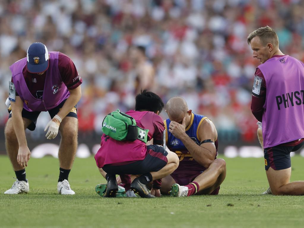 Brandon Starcevich receives attention after suffering another concussion on Saturday. Picture: Darrian Traynor/AFL Photos/via Getty Images