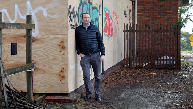 Daniel Ryan outside the abandoned Lifestyle gym, which he wants torn down. Picture: Andy Brownbill