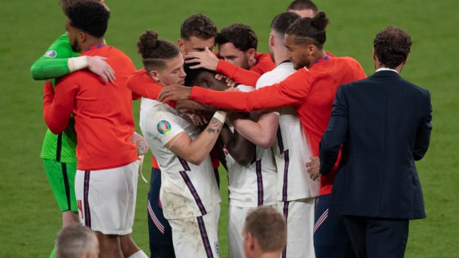 England players console Bukayo Saka after he misses the crucial penalty of the shoot out during the UEFA Euro 2020 Championship Final between Italy and England. Photo: Visionhaus/Getty Images