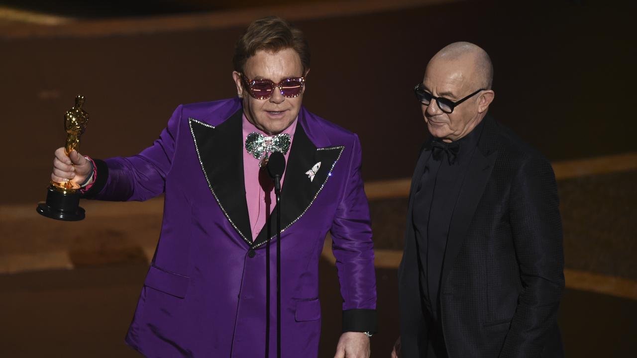 Best Original Song: <i>(I'm Gonna) Love Me Again </i>from <i>Rocketman.</i> Elton John, left, and Bernie Taupin, right, accept the award. Picture: AP