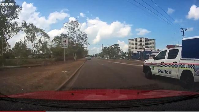 A cop car has narrowly avoided colliding with a Darwin motorist on the Stuart Hwy. Video: Brett Perry