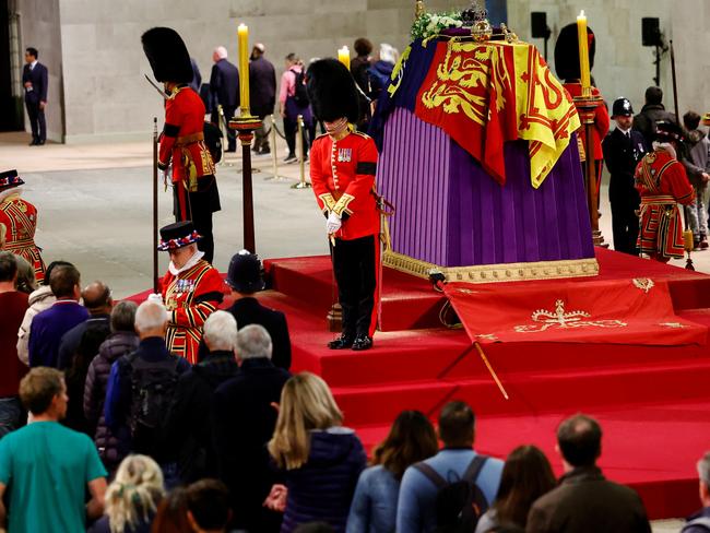 LONDON, ENGLAND - SEPTEMBER 18: Royal guards stand by the coffin of Britain's Queen Elizabeth as members of the public pay their respects, following her death, during her lying-in-state at Westminster Hall on September 18, 2022 in London, England. Members of the public are able to pay respects to Her Majesty Queen Elizabeth II for 23 hours a day from 17:00 on September 18, 2022 until 06:30 on September 19, 2022.  Queen Elizabeth II died at Balmoral Castle in Scotland on September 8, 2022, and is succeeded by her eldest son, King Charles III. (Photo by Sarah Meyssonnier-WPA Pool/Getty Images)