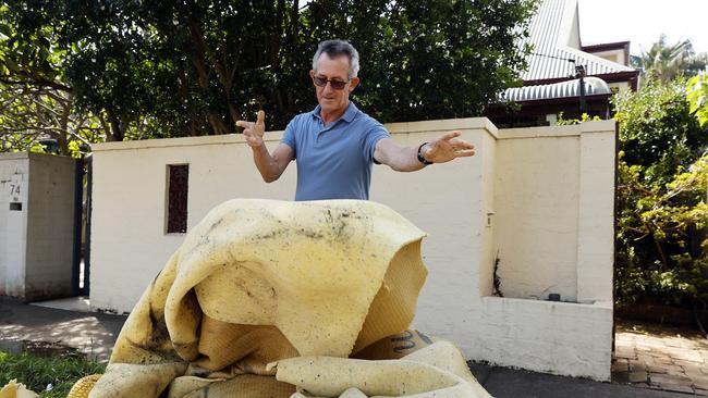 Patrick Burke clearing out his house on Alexander St, Manly which was affected by flooding during Tueday’s storm. Picture: Tim Hunter.