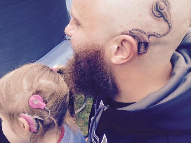 That’s love ... Alistair Campbell with his daughter Charlotte and their cochlear implants. Picture: Facebook