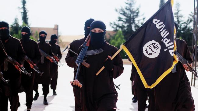 Islamic State of Iraq and the Levant propaganda photo showing masked militants holding the ISIS black banner of Muhammad.