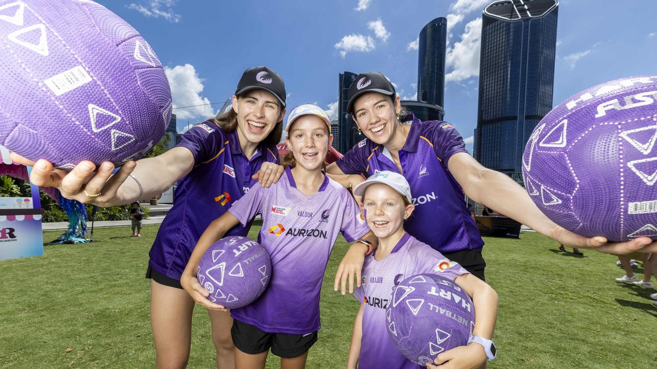 Star Firebirds players Macy Gardner and Emily Moore with two young fans. Picture: Richard Walker