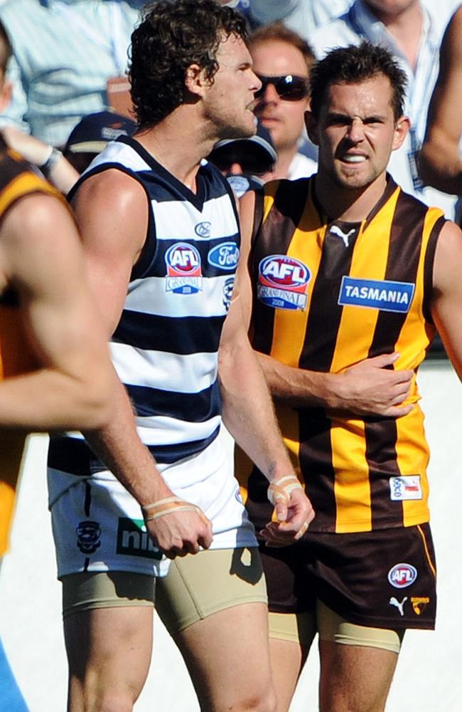 Cameron Mooney takes his frustration out on Luke Hodge.