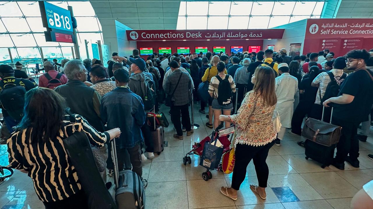 Passengers queue at a flight connection desk at the Dubai International Airport in Dubai on April 17. Picture: AFP