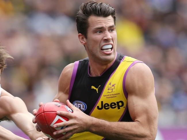 AFL Round 19. 28/07/2018. Richmond v Collingwood at the MCG.  Richmond's Alex Rance charges through the tackle of Collingwood's Josh Thomas  .Pic: Michael Klein