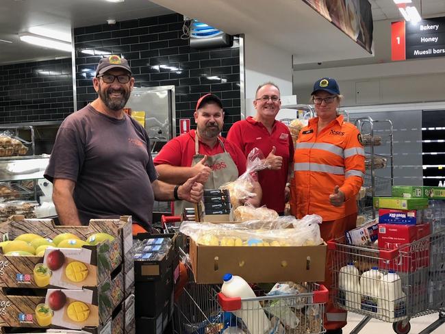 COMM EDITORIAL: RFS Fireys with Coles Batemans Bay team members receiving donations of full trolleys of groceries and fresh produce. Picture: supplied