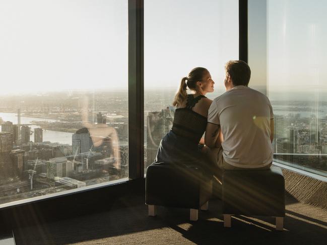 Young couple enjoying the view from the Eureka Skydeck in Melbourne, Australia.