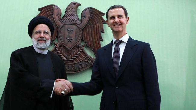 Syria's President Bashar al-Assad shakes hands with his Iranian counterpart Ebrahim Raisi, who was killed in a helicopter crash in May. Picture: Louai Beshara/AFP