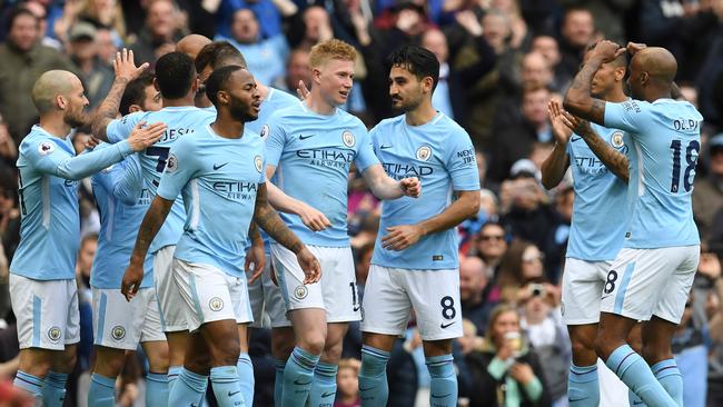 Manchester City players celebrate a goal against Swansea