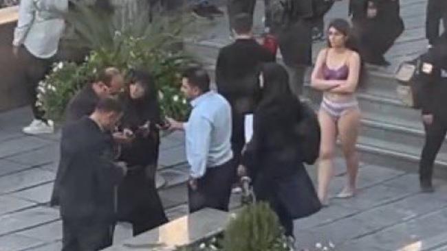 Iranian woman Ahoo Daryaei in her underwear, walking around the campus grounds of her university in Tehran.