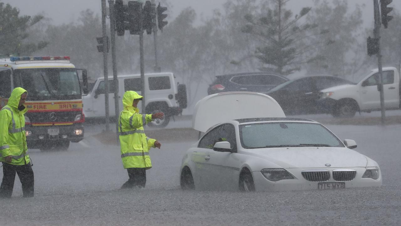 A car is flooded on Queen St in Southport after a storm lashes the Gold Coast. Photograph : Jason O’Brien