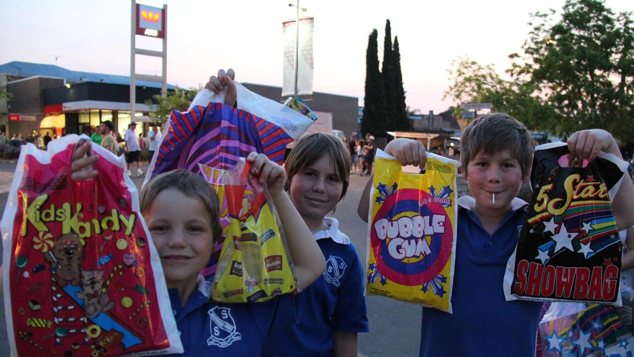 <p>Brothers William, Henry and Edward Thomas got plenty of goodies in the showbags on sale at the Mardi Gras on Friday night. Photo: Erin Smith / Warwick Daily News</p>