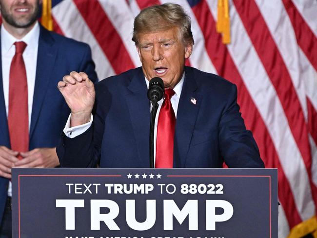 US President and Republican presidential hopeful Donald Trump, with sons Eric (2nd L) and Donald (R), speaks at a watch party during the 2024 Iowa Republican presidential caucuses in Des Moines, Iowa, on January 15, 2024. Trump told Americans Monday "it is time for our country to come together" after he won the Iowa caucuses, cementing his status as the likely Republican challenger to take on President Joe Biden in November's election. (Photo by Jim WATSON / AFP)