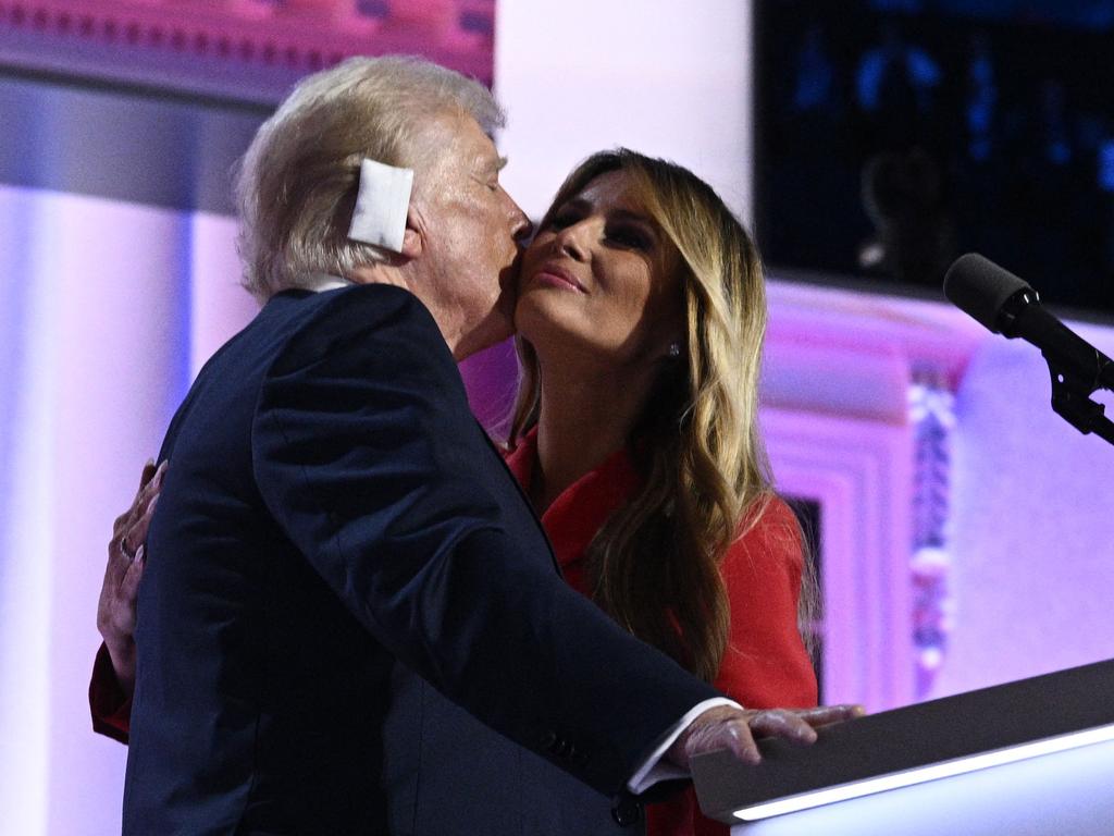 Former US First Lady Melania Trump kisses Donald Trump, who is wearing a large white bandage, on the last day of the 2024 Republican National Convention at the Fiserv Forum in Milwaukee, Wisconsin, on July 18, 2024. Picture: AFP