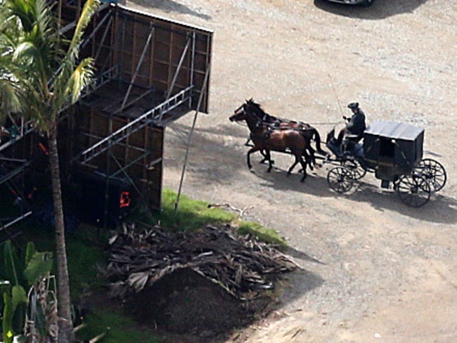 A stagecoach driver rides on to the set. Picture: Glenn Hampson.