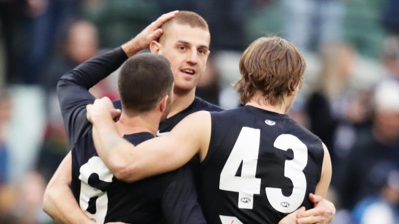 Carlton veteran Kade Simpson celebrates a win last season with Will Setterfield and Liam Jones.