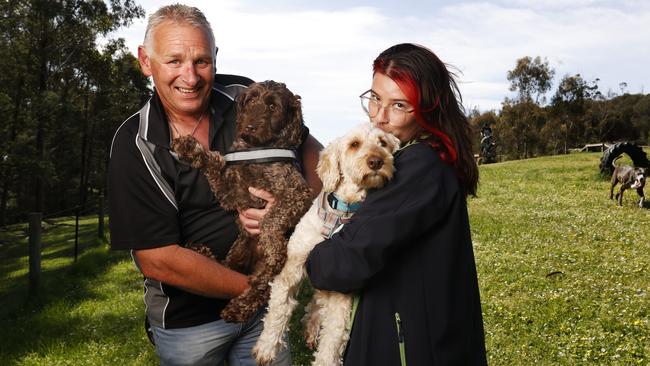 Mick Kelleher with Max who is 3 and Alex Zammitt with Bentley who is 4 at Suncoast Dog Park Blackmans Bay with some of the dogs rescued from the puppy farm shut down in Tasmania that have now been rehomed. Picture: Nikki Davis-Jones