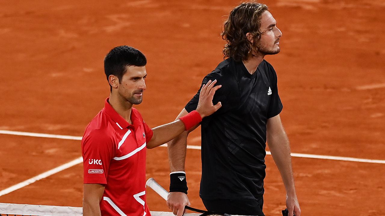 PARIS, FRANCE - OCTOBER 09: Novak Djokovic of Serbia embraces Stefanos Tsitsipas of Greece at the net following victory in their Men's Singles semifinals match on day thirteen of the 2020 French Open at Roland Garros on October 09, 2020 in Paris, France. (Photo by Shaun Botterill/Getty Images)