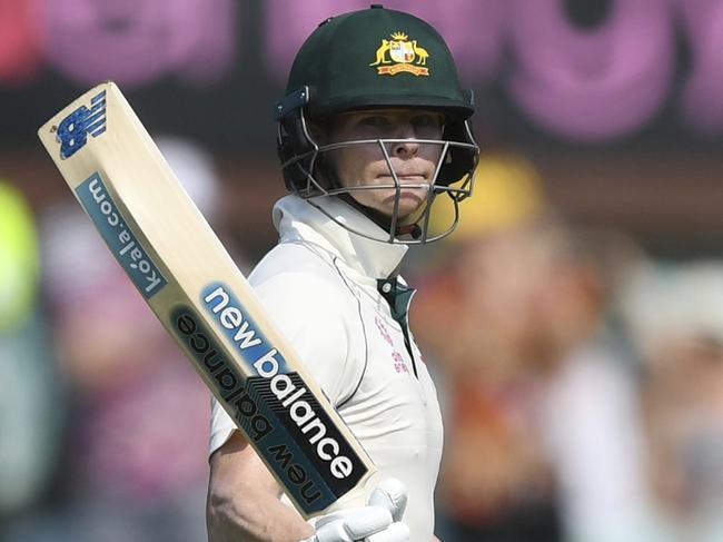 Smith celebrates bringing up his half century. Picture: AP