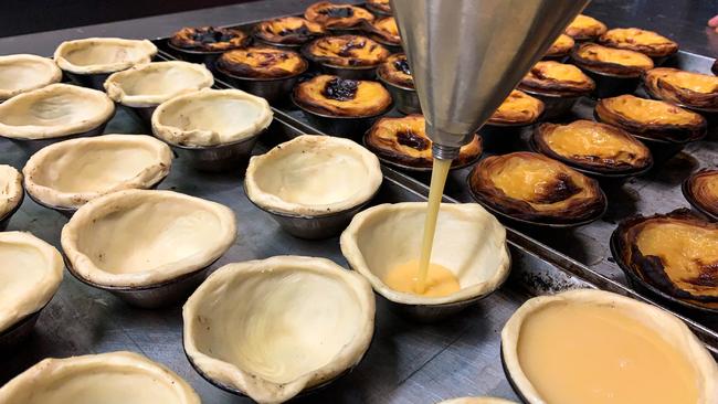 Custard being poured into shells before they’re baked. Picture: Jenifer Jagielski