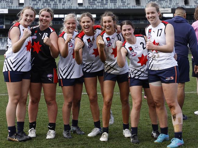 Timeka Cox of the Futures Team White, Jessica Rentsch of the Futures Team Black, Melanie Staunton, Georgie Cleaver, Kaitlyn Srhoj, Lila Keck and Anjelique Raison of the Futures Team White pose for a photo after the NAB Futures League match at GMHBA Stadium.