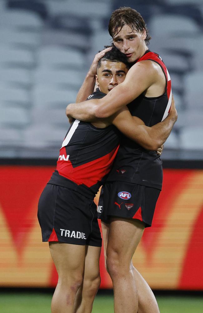 Isaac Kako of the Bombers gets a hug of Harrison Jones just before the final siren. Picture: Michael Klein